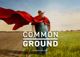 Common Ground text with farmer standing in a field with a red cape
