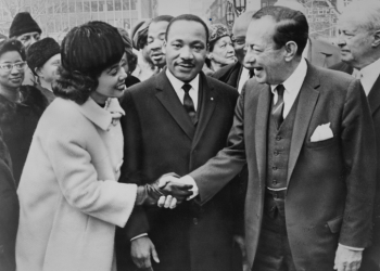 Photograph shows Coretta Scott King shakes hands with New York City Mayor Robert Wagner as Dr. Martin Luther King, Jr. stands between them.