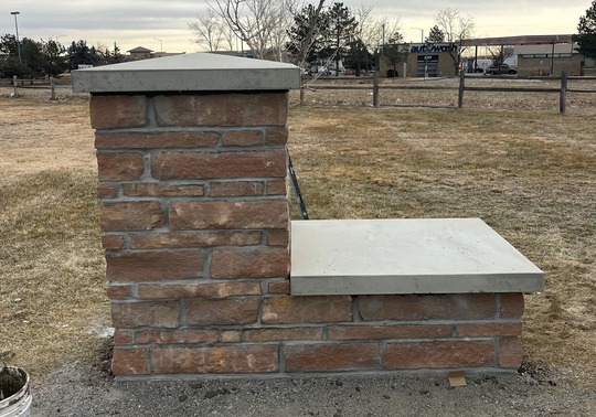 Brick base of the monument being installed at Asti Park.