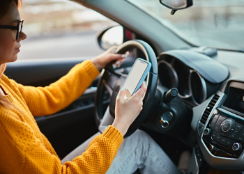 A person on their phone while driving