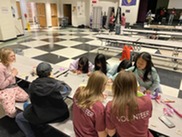 Children and volunteers creating crafts at Parent's Night Out