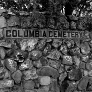 Black and white photo of the Columbia Cemetery stone sign