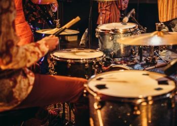 Close up of a drummer performing with a band.