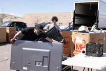 Volunteers sort flat screen TVs at the Hard to Recycle event