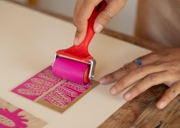 Person making a block print craft.
