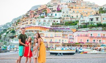 Four people pose for a photo traveling in Italy