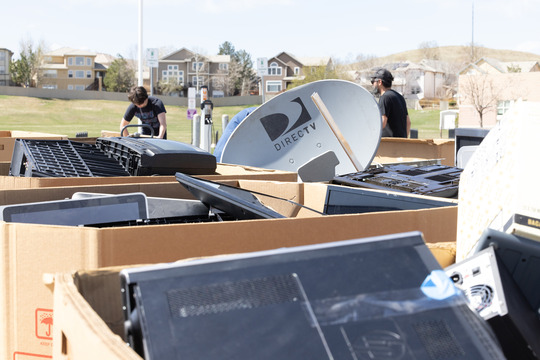 Full bins of collected recyclables sitting in a parking lot during the hard to recycle event.