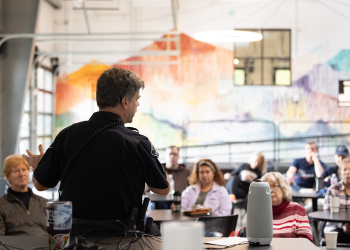 A Boulder County Sheriff's officer speaks to the crowd at Chat with the Chief