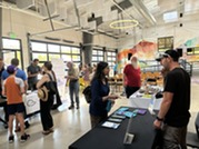 Attendees talk to a representative at the Electrification Expo
