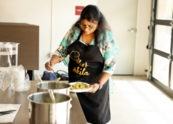 Chef Akila dishes out food during an Indian Cooking Class at the Superior Community Center