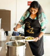 Chef Akila dishes out food during an Indian Cooking Class at the Superior Community Center