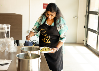 Chef Akila dishes out food during an Indian Cooking Class at the Superior Community Center