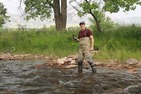 A person collects water quality data in Boulder County