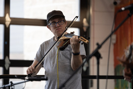 a man playing violin on open mic night at the SCC
