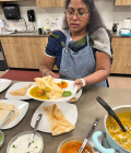 akila arumugam preparing an indian dish
