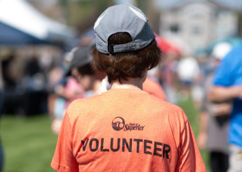 A person in an orange Town of Superior volunteer shirt