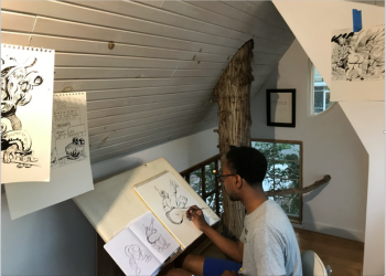 A person draws in a studio