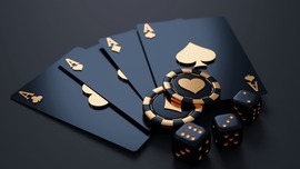 picture of black playing cards, dice, and poker chips with gold lettering on a black background