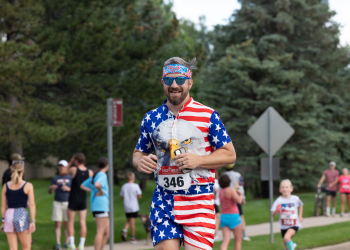 A person in an eagle outfit runs down Rock Creek Parkway