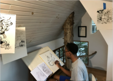 A person drawing in a treehouse studio