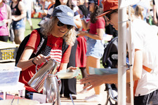 Woman pouring syrup on her pancakes during the festival.