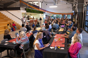 A crowd sits at tables during A Taste of Nepal at the Superior Community Center