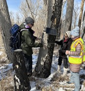 WHET volunteers check on a wildlife monitoring camera