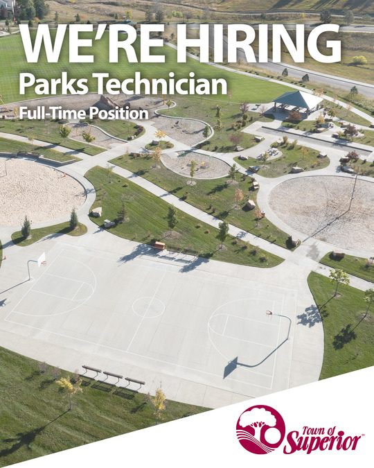 We're hiring text overlaying a drone shot of wildflower park.
