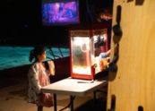 A young girl waits for popcorn during movie night at the pool