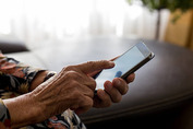 female senior hands using a smartphone