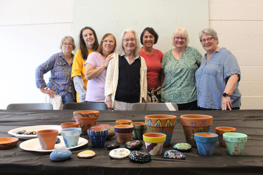 A group of Superior Seniors pose with handpainted flower pots
