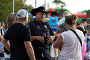 A Boulder County Sheriff chats with residents at National Night Out in Superior