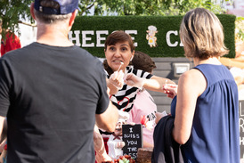 Person handing out cheese samples in a well designed booth.