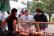 Two people buy bread at the Superior Fall Fest 