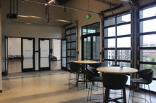photo of the inside of the civic space with high top tables and chairs