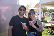 Two people hold cups of chili at Superior's Chili & Beer Fest