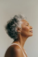 older woman in a tank top making a relaxed/meditating face