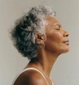 older woman in a tank top making a relaxed/meditating face