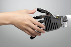 person shaking hands with a robot