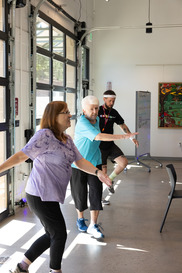 2 seniors copying workout from instructor