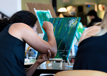 A person paints during an art class at the Superior Community Center