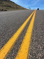 New yellow stripes on a road in Superior
