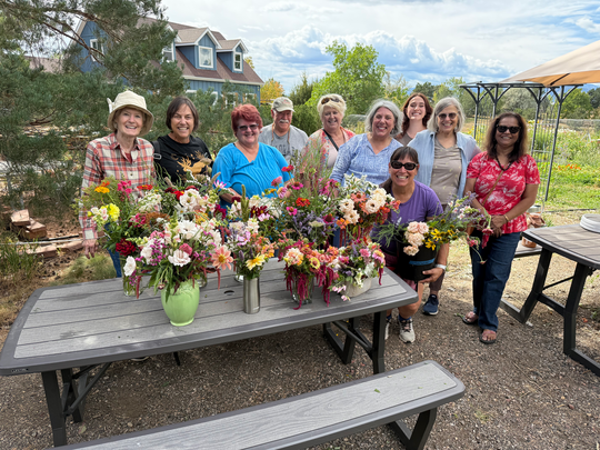 Ten members of the Superior Seniors Gardeners Unite group pose with handmade bouquets 