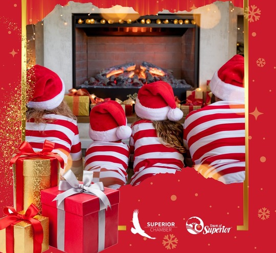 Four people sitting in front of a fireplace.