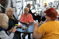 Superior Seniors play cards at a table at the community center