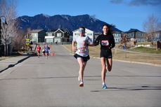 Two people running through Old Town in Superior.