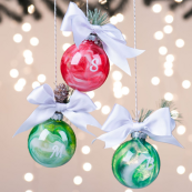 Red and green glass pour paint ornaments with white bows 