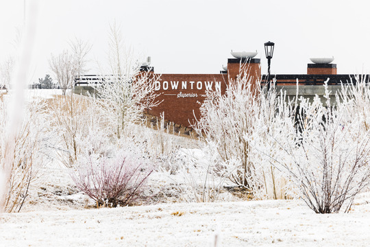 Downtown Superior sign surrounded by winter snow.
