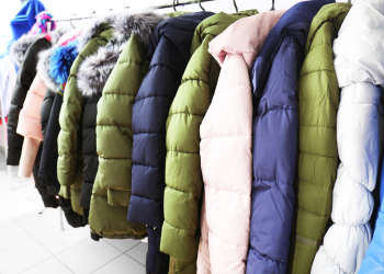 a rack of coats in various colors