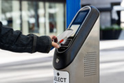 A person uses a phone to pay for RTD fare